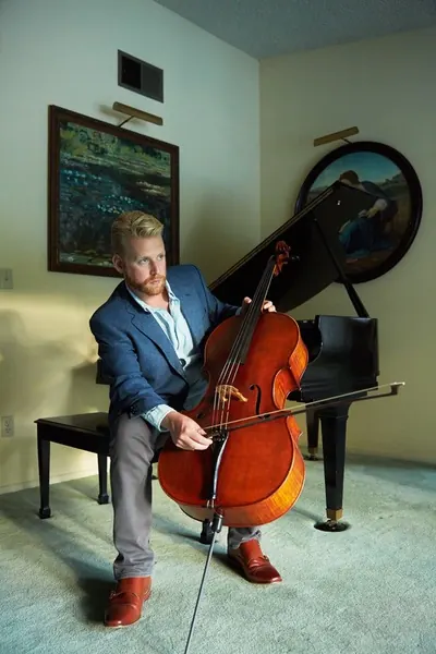 Daniel Grab seated with his cello
