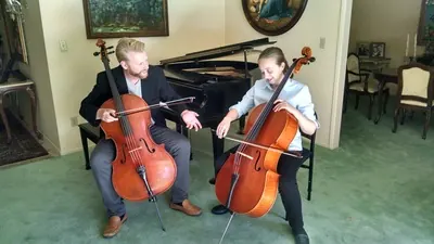 Daniel and a student playing side by side