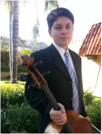 Ernie Jr., one of Daniel’s longtime students, holding his cello